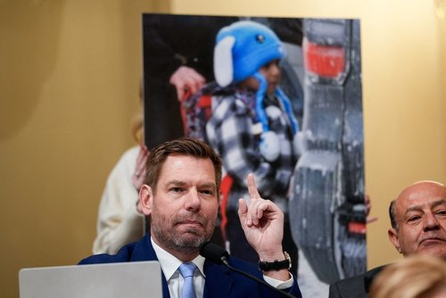 FILE PHOTO: An aide holds up an image of 5-year-old Liam Conejo Ramos. REUTERS/Kent Nishimura/File Photo