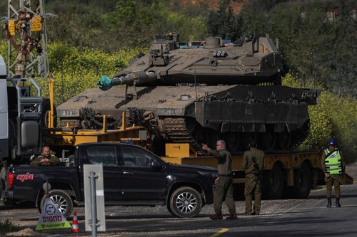 An Israeli tank is transported on the Israeli side of the border with Lebanon, amid escalation between Iran-backed Hezbollah and Israel and the U.S.-Israeli conflict with Iran, in northern Israel