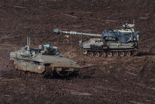An armoured personnel carrier (APC) and a self-propelled artillery unit at the Israeli side of the border with Lebanon, amid escalation between Iran-backed Hezbollah and Israel