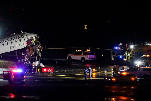 Emergency crews work around an Air Canada Express jet that had collided with a ground vehicle at LaGuardia Airport in Queens, New York, U.S. March 23, 2026. REUTERS/Bing Guan