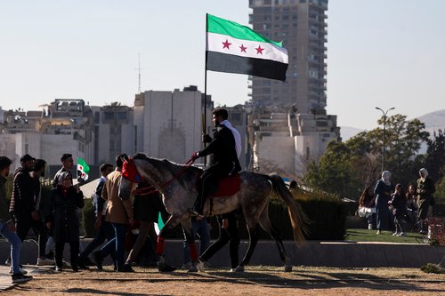 People gather after Syria's Bashar al-Assad was ousted, in central Damascus