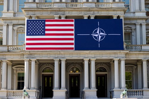 FILE PHOTO: The U.S. flag alongside the NATO flag in Washington