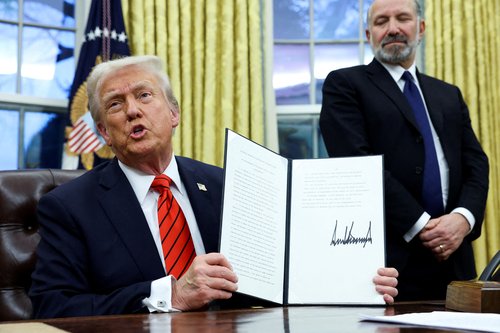 U.S. President Donald Trump signs an executive order in the Oval Office of the White House in Washington