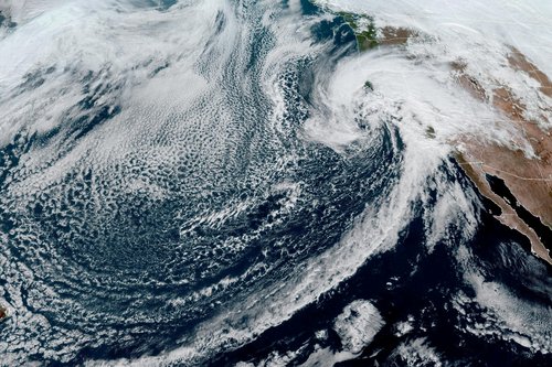 FILE PHOTO: Heavy cloud system moves towards the U.S. west coast in a composite image from the NOAA GOES-West weather satellite
