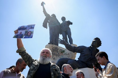 Protesters, including members of the media, attend a vigil to condemn the killing of journalists, a day after journalist Amal Khalil was killed in an Israeli strike, in Martyrs' Square, Beirut