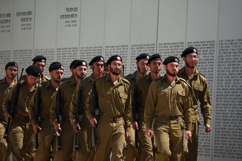 Military personnel march near a wall with names of fallen soldiers, on Israel's Memorial Day, which commemorates fallen soldiers of Israel's wars and Israeli victims of hostile attacks, in Latrun, Israel April 21, 2026.