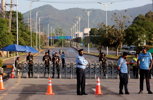 Police officers stand guard next to a barricade near Serena Hotel, as Pakistan prepares to host the U.S. and Iran for the second round of peace talks, in Islamabad, Pakistan, April 25, 2026.