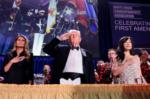U.S. President Donald Trump, with first lady Melania Trump and CBS News senior White House correspondent Weijia Jiang, salutes during the annual White House Correspondents' Association dinner in Washington, D.C., U.S., April 25, 2026.