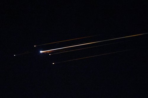 Streaks of light illuminate the sky during an interception attempt, amid the U.S.-Israeli conflict with Iran, as seen from Ashkelon, Israel, April 4, 2026.