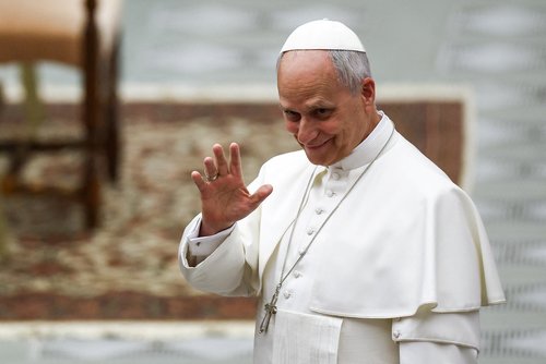 Pope Leo XIV waves, as he arrives for a swearing-in ceremony of new Swiss Guards in the Paul VI Hall at the Vatican, May 6, 2026.