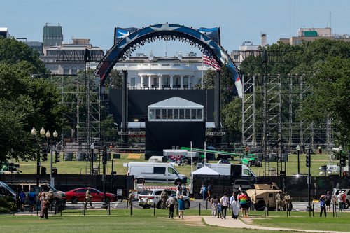 FILE PHOTO: People walk and stand nearby as construction continues on the Ellipse and a temporary arena for the UFC Freedom 250 fight card at the White House in Washington, D.C., U.S., June 5, 2026. REUTERS/Kylie Cooper/File Photo