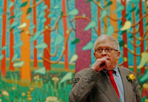 FILE PHOTO: British artist David Hockney poses in front of a detail of his painting "The Arrival of Spring in Woldgate, East Yorkshire in 2011 (twenty-eleven)" at the Royal Academy of Arts in London January 16, 2012