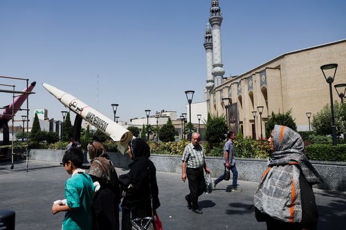 People walk next to a symbolic mock-up of an Iranian missile, on a street in Tehran, Iran, June 11, 2026.