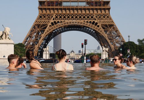 People cool off in the Trocadero Fountain next to the Eiffel Tower as temperatures rise during a heatwave affecting a large part of the country, in Paris, France, June 22, 2026. REUTERS/Abdul Saboor