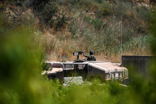 Israeli military vehicles drive on an Israeli road by the Israel-Lebanon border, in northern Israel, June 18, 2026