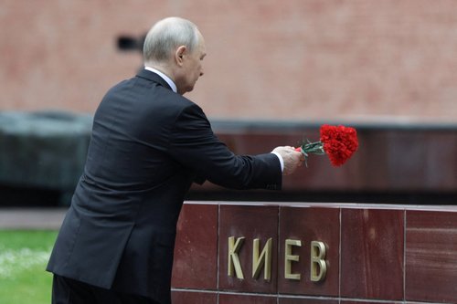 Russian President Vladimir Putin lays flowers at the Hero Cities memorial plates by the Kremlin wall during a ceremony on the Remembrance and Sorrow Day, marking the 85th anniversary of the Nazi German invasion into the Soviet Union in World War II