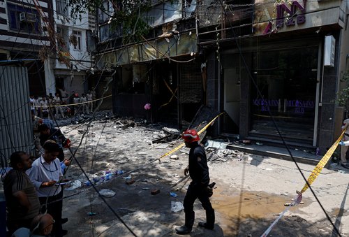 Firefighters and police officers work at the site after a fire at a hotel in New Delhi, India, June 3, 2026. REUTERS/Adnan Abidi
