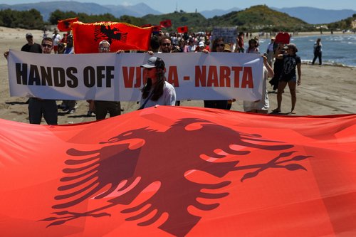 Protesters hold Albanian national flags during a protest against a luxury resort plan by a company linked to U.S. President Donald Trump's son-in-law, Jared Kushner, on an environmentally sensitive part of the Adriatic coast