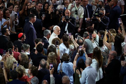 Pope Leo XIV looks towards faithful holding phones as he attends the meeting "Building Networks with the World of Culture, Art, Economy and Sport" at the Movistar Arena, during his apostolic journey in Madrid, Spain, June 7, 2026.