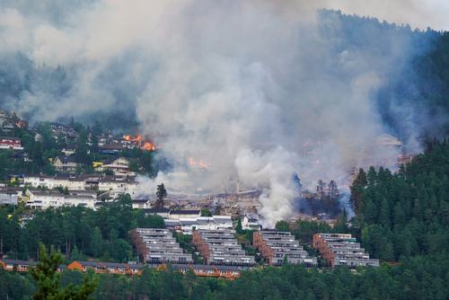 Smoke rises from a large fire that has spread from terraced houses in Krokstadelva. Thomas Fure/NTB/via REUTERS