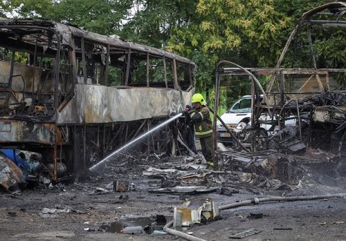 A firefighter works at the site of a bus parking hit by a Russian drone strike, amid Russia's attack on Ukraine, in Odesa, Ukraine, July 13, 2026.