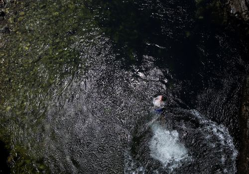 A boy swims in the Treska River after jumping in to cool off from the hot weather near Skopje, North Macedonia, July 19, 2026.