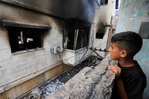 A Palestinian boy inspects the site of an Israeli strike on a house in Gaza City, July 21, 2026.