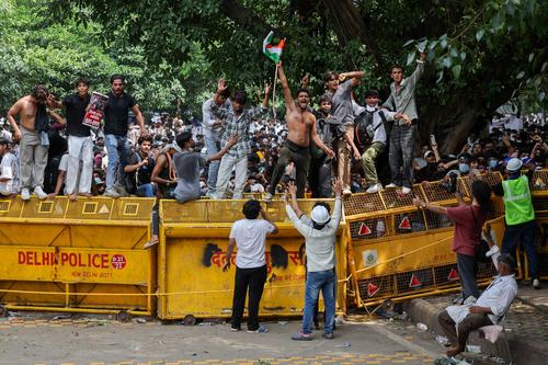 Supporters of India's Cockroach Janta Party (CJP) celebrate after India's Education Minister Dharmendra Pradhan resigned following days of protests over National Eligibility cum Entrance Test (NEET) examination paper leaks