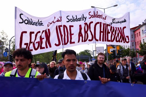 People carry a banner reading: "Against all deportations", during protests against a two-day party convention of Germany's far-right Alternative for Germany (AfD) party, in Erfurt, Germany, July 4, 2026. REUTERS/Thilo Schmuelgen