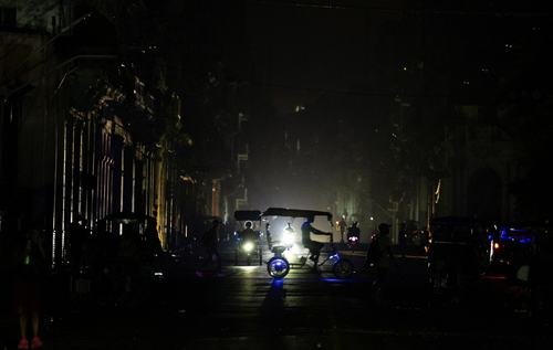A bicitaxi driver rides across a street as Cuba's national electrical grid collapsed again on Monday while the government was trying to restore power following a nationwide blackout on Sunday, in Havana, Cuba August 3, 2026. REUTERS/Norlys Perez