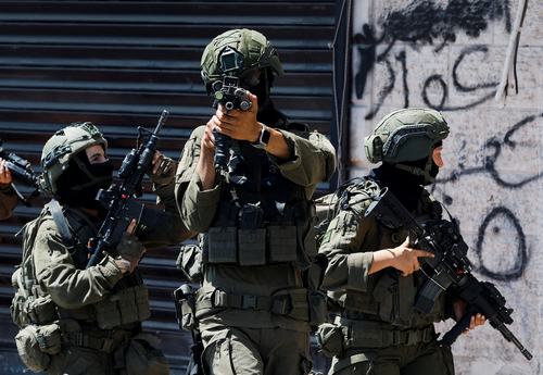 Israeli forces take part in a raid in Qalandia refugee camp, in the Israeli-occupied West Bank, August 5, 2026.