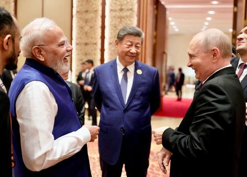 India's Prime Minister Narendra Modi shares a moment with Russian President Vladimir Putin as Chinese President Xi Jinping looks on during day two of the BRICS Summit in New Delhi, India, September 13, 2026.