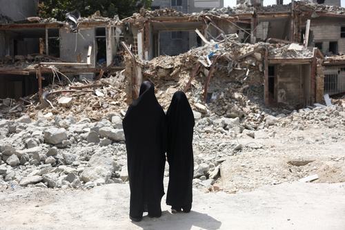 Iranian women look at a building, which was damaged in a U.S. and Israeli strike in March, in Tehran, Iran, August 22, 2026.
