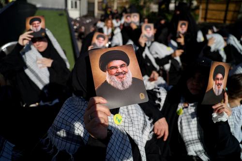 Hezbollah supporters hold images of late former Hezbollah leader Hassan Nasrallah at a ceremony held by Hezbollah to commemorate the second anniversary of Hassan Nasrallah's killing by Israel, in Beirut's southern suburbs, Lebanon, September 27, 2026.