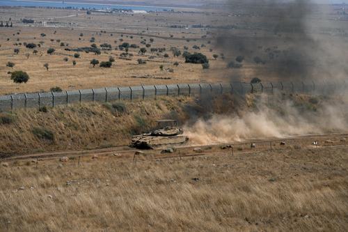 An Israeli tank drives along the ceasefire line between the Israeli-occupied Golan Heights and Syria, on its Israeli side August 20, 2026.