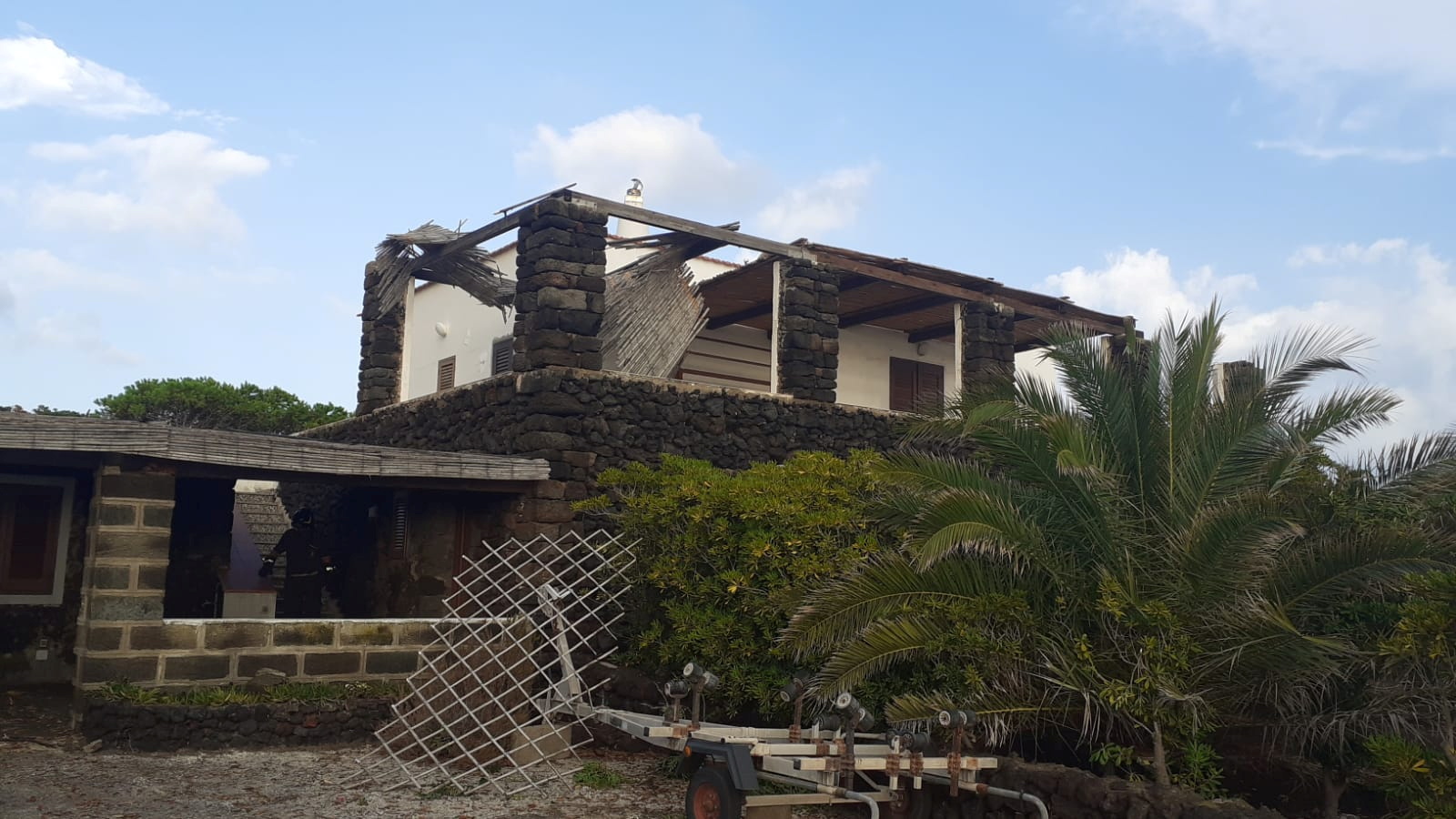 Firefighters inspect a damaged building after a tornado hit the small Italian island of Pantelleria,