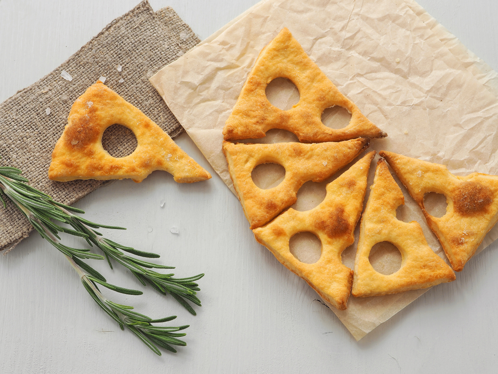 Cheese,Slice,Shape,Crackers,Upon,Parchment,With,Rosemary,Stem