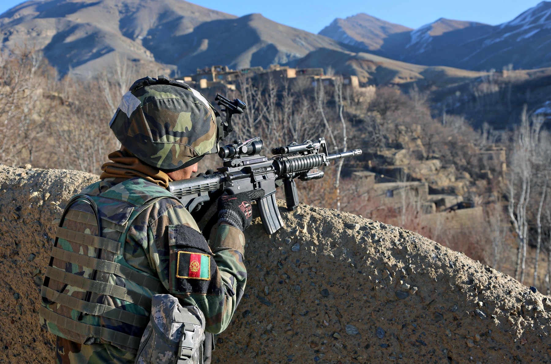 Afghan special operation force soldiers survey the valley for any suspicious activity during an operation to capture Taliban leaders January 15, 2014 in Ghorband district, Parwan province, Afghanistan.