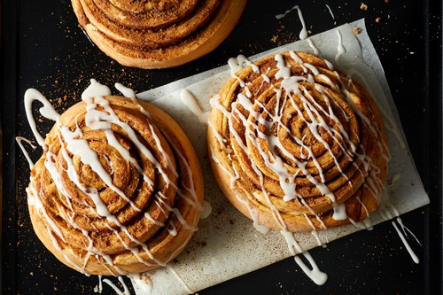 Cinnamon Rolls drizzled with Icing on wax paper