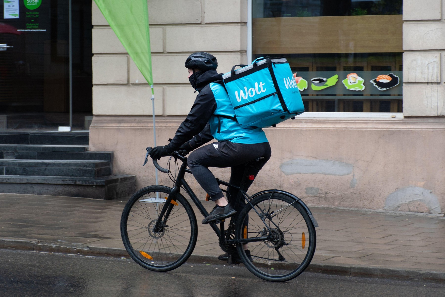 Wolt, online food ordering and delivery service that takes orders via a mobile app, rider with bike