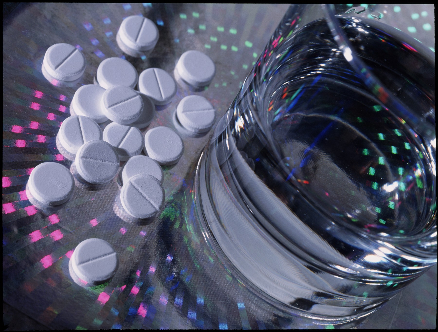 Paracetamol painkillers next to glass of water