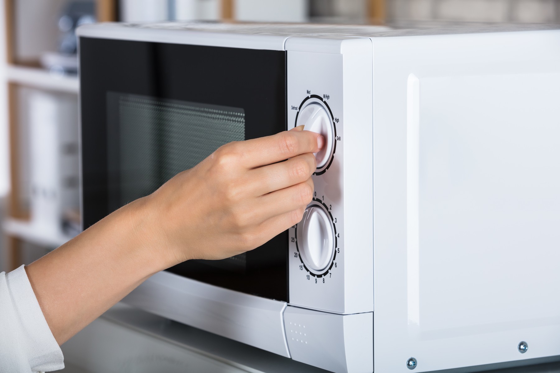 Woman Using Microwave Oven