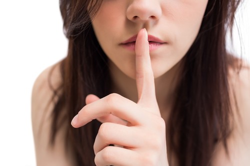 Close up on pretty brunette keeping secret