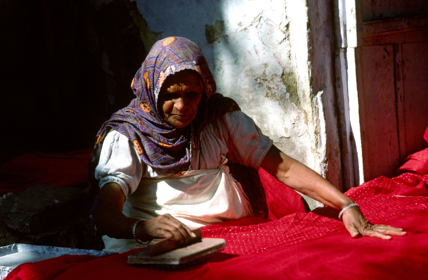 India Rajasthan crafts Ahar near Udaipur old woman block printing resist dots onto fabric