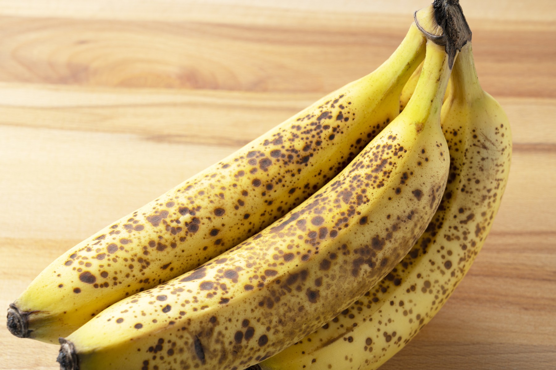 A banana out of a sugar pot placed on a wooden background