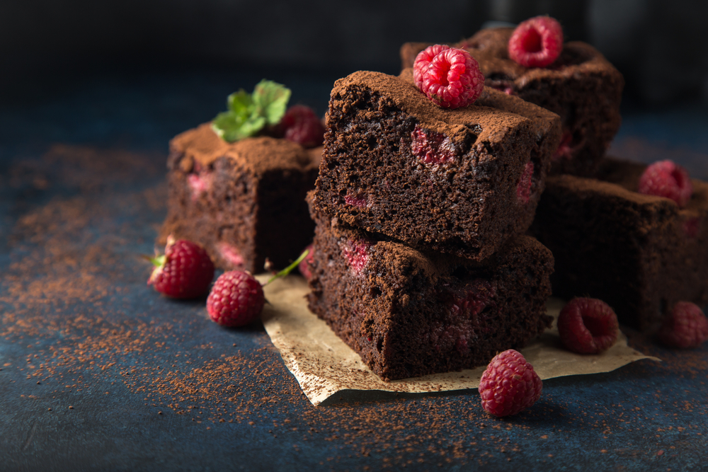 Raspberry,Brownies,Served,With,Fresh,Berries,,Dark,Background,,Selective,Focus
