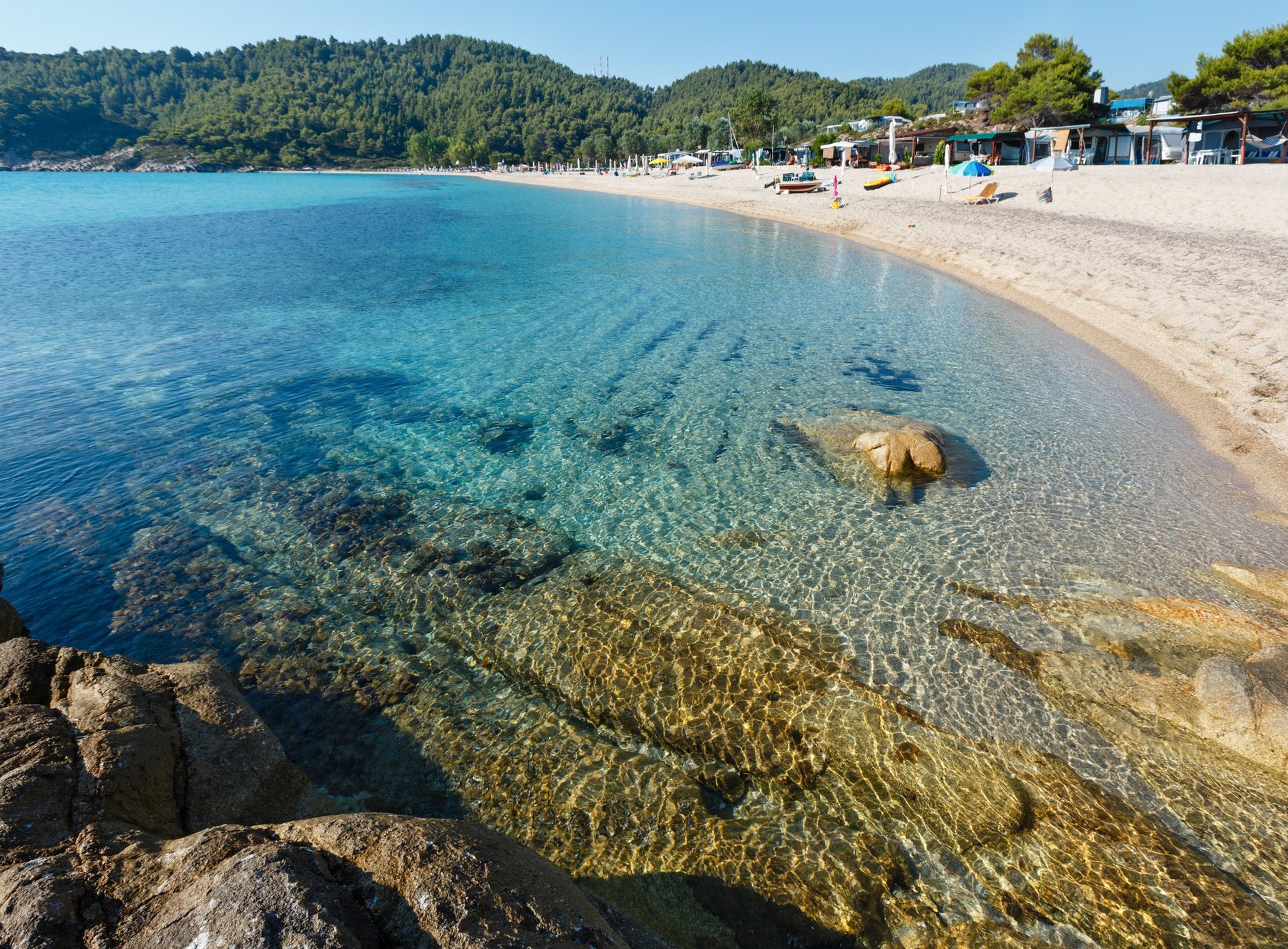 Camping on summer morning Platanitsi beach on Sithonia Peninsula (Chalcidice, Greece). People are unrecognizable.