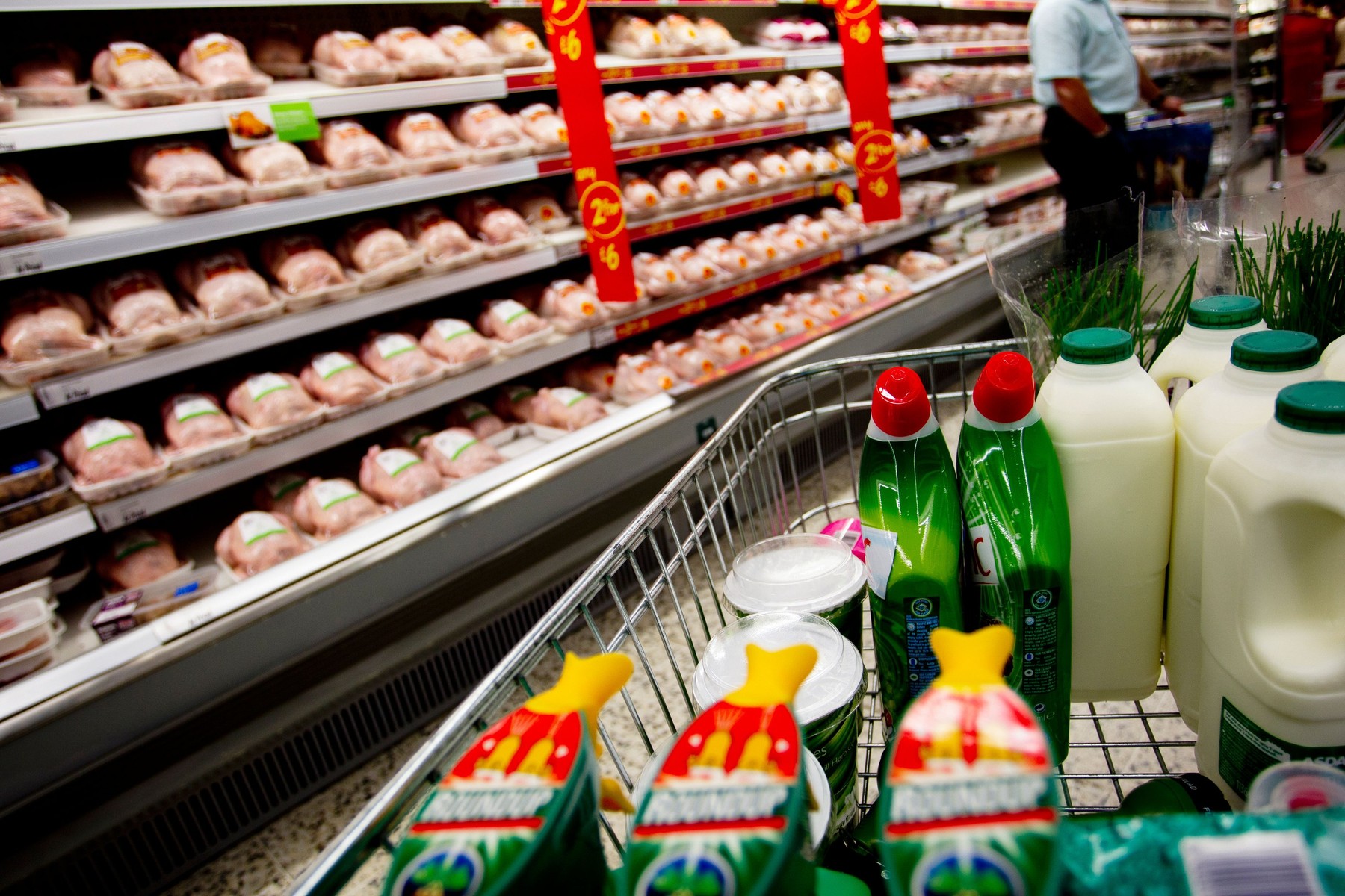 Super Market trolley with shelves full of chicken on offer at ASDA