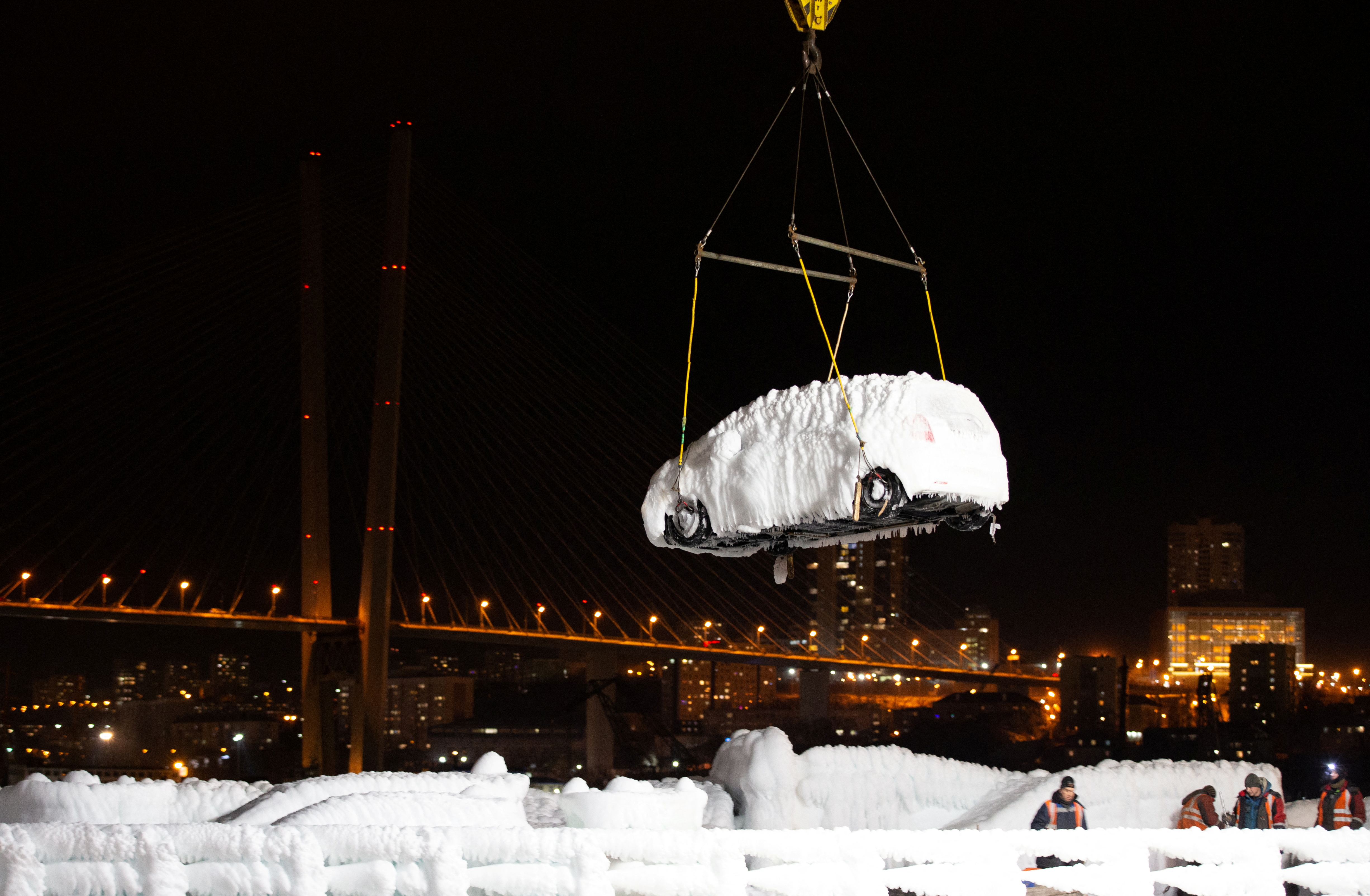 An ice-covered vehicle is unloaded from the cargo ship Sun Rio in the port of Vladivostok