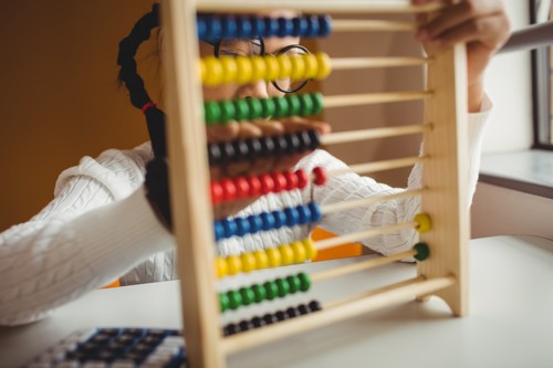 Schoolchild using a slide rule